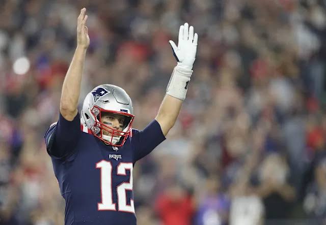Brady throwing a pass in New England